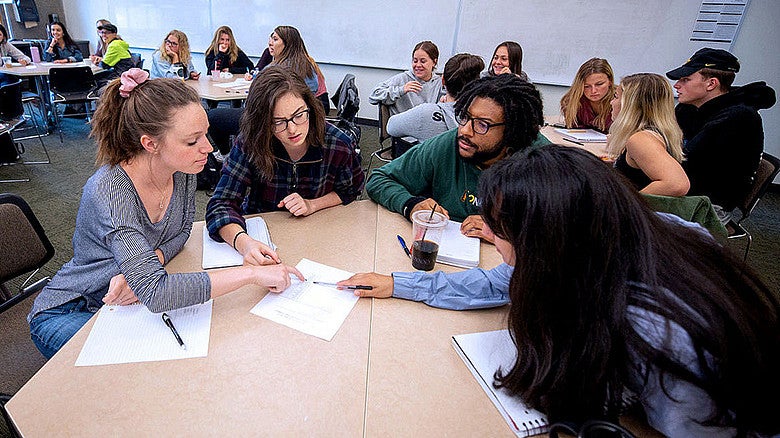 group of UO students working together at a table