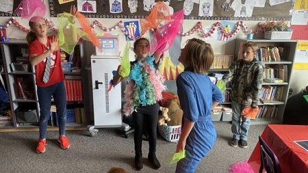 Elementary students dance in classroom