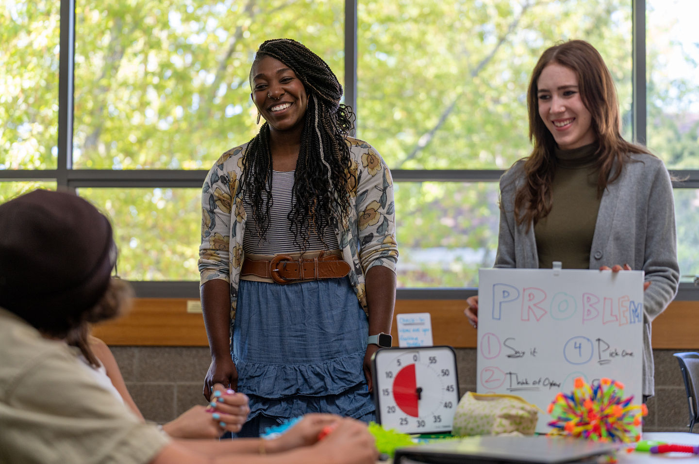 A teacher and student laugh