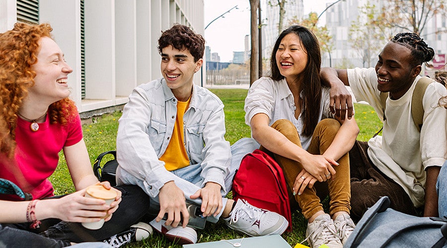 Group of college students sitting together and laughing 