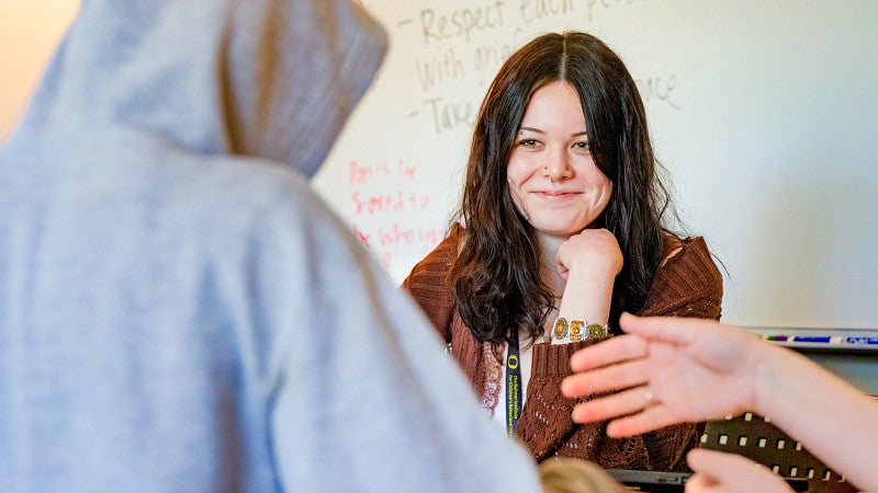 a student from the University of Oregon Ballmer Institute for Children's Behavioral Health meets with a teenager