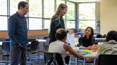 A teacher and a student teacher teach middle schoolers