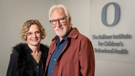 Lisa Redekop and Les Koski standing in front of a Ballmer Institute for Children's Behavioral Health sign.