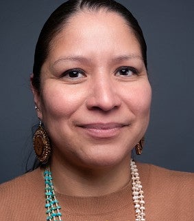a woman smiles for a portrait