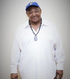 a man smiles for a portrait