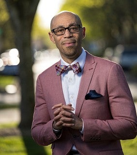 Man poses and smiles for a portrait