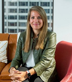 a woman sits in a chair for a portrait
