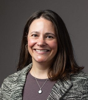 a woman smiles for a professional headshot