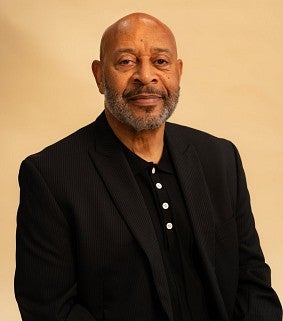 man sits for a portrait