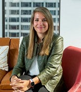 a woman sits in a chair for a portrait