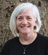 a woman smiles for a portrait