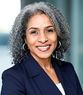 a woman smiles for a portrait