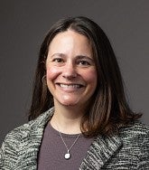 a woman smiles for a professional headshot