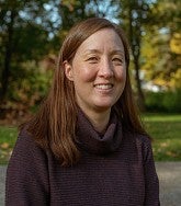 a woman smiles for an outdoor portrait